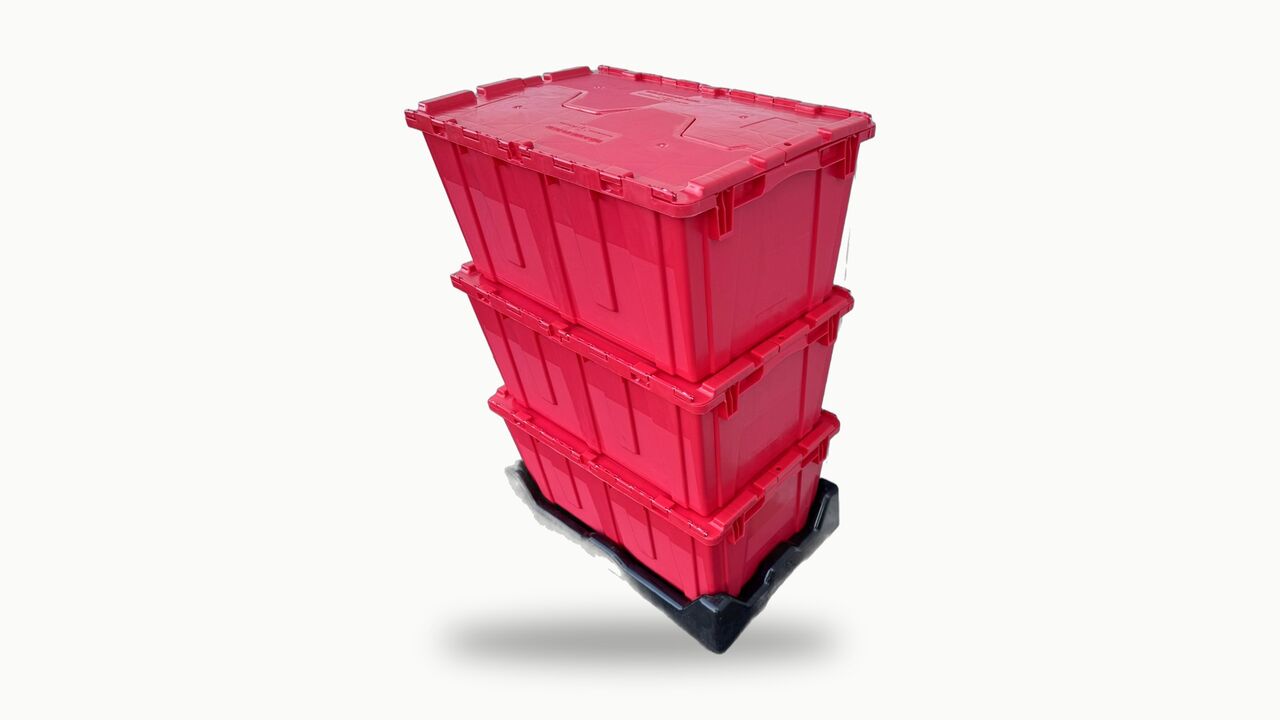 A stack of three red moving totes with attached red lids on a black dolly